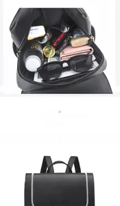 Internal storage detail of black leather backpack showing space for daily essentials