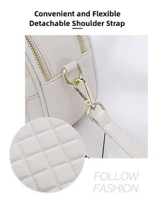 Detail showing the detachable shoulder strap with golden metal hook on quilted bag