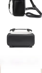 Detail view of adjustable straps and reinforced bottom on black and white backpack