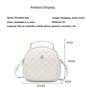 Close-up of white quilted PU crossbody bag showing dimensions 21x19x9cm with gold hardware