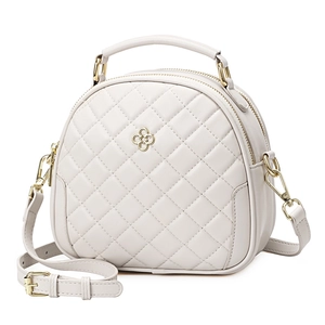 Elegant white quilted crossbody bag with golden floral logo and dual zipper closure