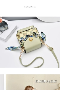 Close-up of mint green crossbody bag featuring checkered cat pattern and floral scarf