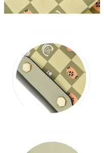Detail of checkered leather bag featuring cat print and golden hexagonal metal feet