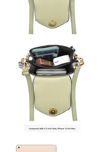 Internal view of green crossbody bag with multi-layer compartments next to a 9.7 inch iPad