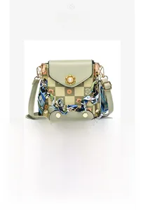 Detail of mini crossbody phone bag with olive green checkered pattern and silk scarf handle