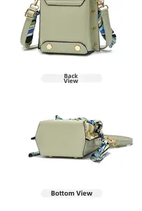 Detail view showing the back and bottom of the light green mini crossbody bag with metal studs