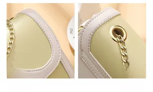 Détails d'un sac à bandoulière jaune montrant les coutures et la chaîne dorée