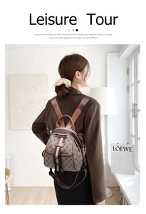 Detail view of retro brown leather backpack with monogram pattern and metal buckle closure