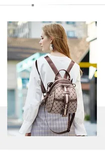 Rear side view of a mini brown monogram backpack worn by a model in the city street