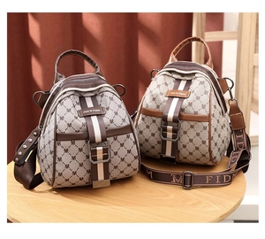 Detail of printed canvas mini backpack featuring M-letter pattern and leather trim