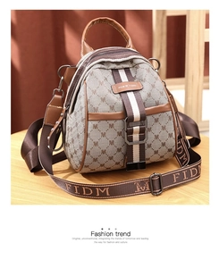 Detail of the vintage monogram pattern with elegant leather piping and metal buckle closure