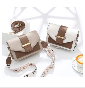 Detailed view of color-block leather crossbody bags with adjustable wide fabric straps