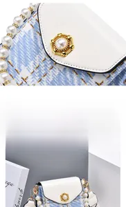 Detail of blue and white tweed bag with pearl handle and golden pearl buckle clasp