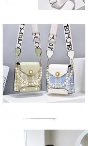 Detail of plaid tweed crossbody bags with pearl handles and gold flower clasps