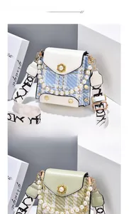 Detail of plaid mini crossbody bags with pearl chains and woven jacquard straps