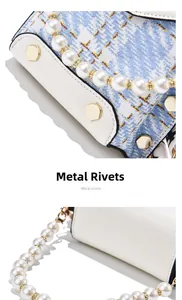 Detail of white leather and blue tweed crossbody bag with gold rivets and pearl strap