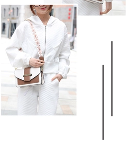 Chic two-tone crossbody bag with ethnic embroidered strap styled on a waffle knit set