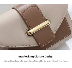 Detail view of contrast stitching and gold metal buckle on two-tone leather bag