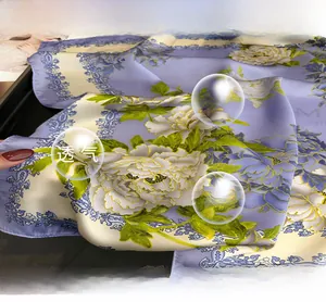 Vue macro d'un foulard en soie avec pivoines blanches et texture de tissu lilas lisse