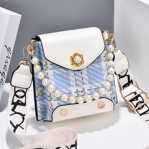 Plaid tweed mini crossbody bag with pearl lock and graffiti strap on geometric display