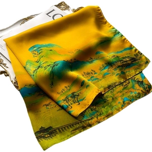 Classic yellow silk scarf with traditional landscape painting on white magazine