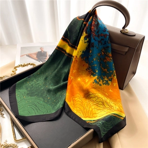 Détail d'un foulard en soie à imprimé abstrait drapé sur un sac à main de luxe