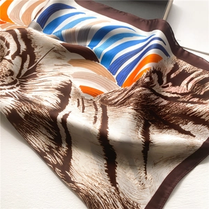 Tiger print silk scarf with blue and orange geometric stripes on a white background