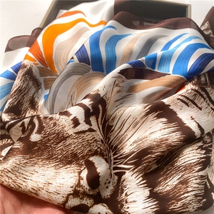 Luxurious tiger pattern silk scarf featuring vibrant orange and blue abstract art prints