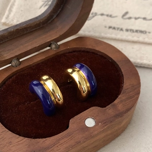 Detail showing vintage gold and deep indigo enamel semi-hoop earrings in velvet box