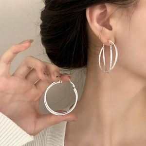 Luxurious silver geometric cross hoop earrings with shimmering textured finish for women