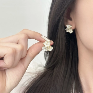 Elegant vintage gold floral stud earrings with white enamel petals for women