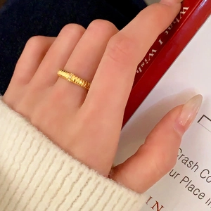 Minimalist gold ring with textured spiral band and small white gemstone inlay for women