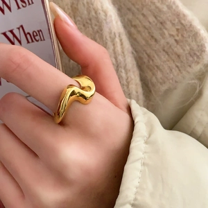 Minimalist gold wavy ring featuring an irregular organic design with a high-polished finish