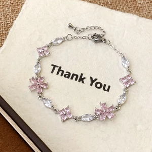 Elegant floral silver bracelet with pink zircons on a Thank You gift card background