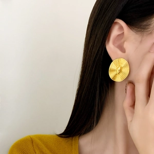 Golden round textured stud earrings for women with a vintage radial woven metal pattern