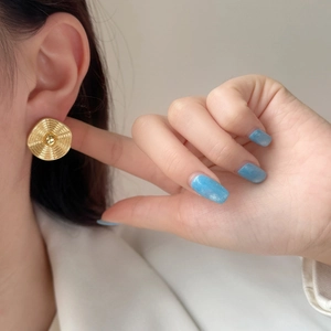 Elegant gold-plated round stud earrings with spiral texture and center bead design