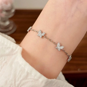 Elegant silver butterfly bracelet with sparkling zircon stones worn on a woman's wrist