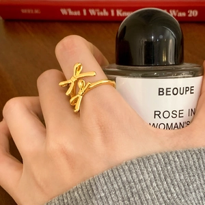 Elegant gold double bow open ring for women with polished finish on a finger