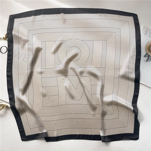 Detailed close-up of striped silk square scarf showing luxury texture and hand-rolled edges