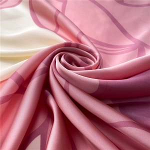 Detailed view of pink and purple floral silk scarf showing satin luster and drape