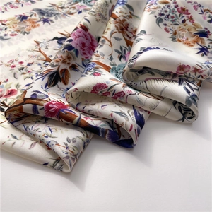 Detail of floral silk scarf featuring vintage blossom patterns and satin texture