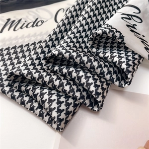 Classic black and white houndstooth silk scarf with elegant cursive text detail