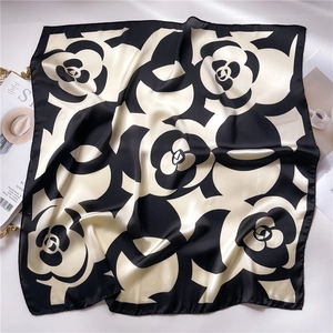 Detail of silk camellia square scarf with hand-rolled edges and satin finish