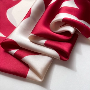 Macro shot of camellia silk scarf showing elegant draped folds and glossy texture