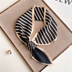 Detail of striped narrow silk scarf with diagonal ends and subtle silk luster