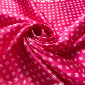 Macro shot of rose pink silk scarf showing smooth texture and white grid patterns