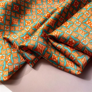 Close-up of geometric lattice and floral patterns on silky satin square scarf