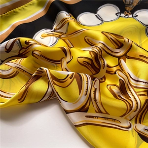 Detail of silk scarf showing luxury chain print and smooth satin texture folds