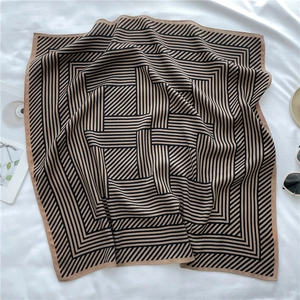Close-up of lightweight silk-like square scarf featuring chic black and beige striped patterns