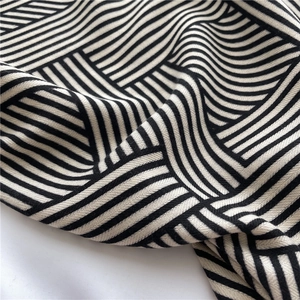 Detail of herringbone pattern and soft texture on black and white striped scarf fabric